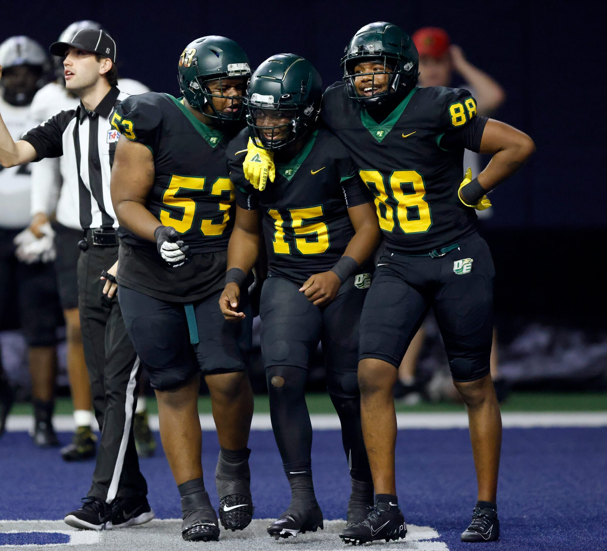 DeSoto quarterback Darius Bailey (15) celebrates his second quarter touchdown run by...