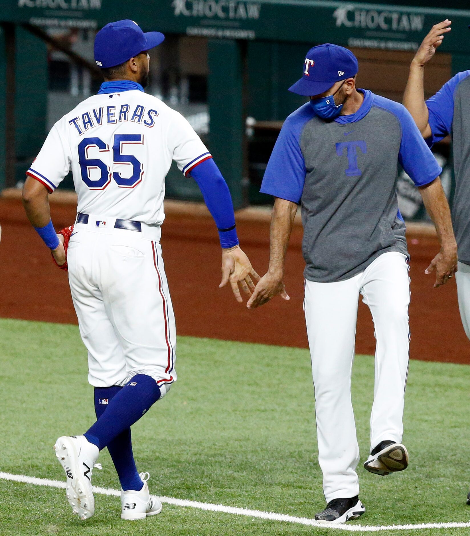 Texas Rangers center fielder Leody Taveras (65) is congratulated by manager Chris Woodward...