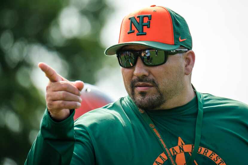Garland Naaman Forest football coach Jesse Perales makes a point during a freshman team...