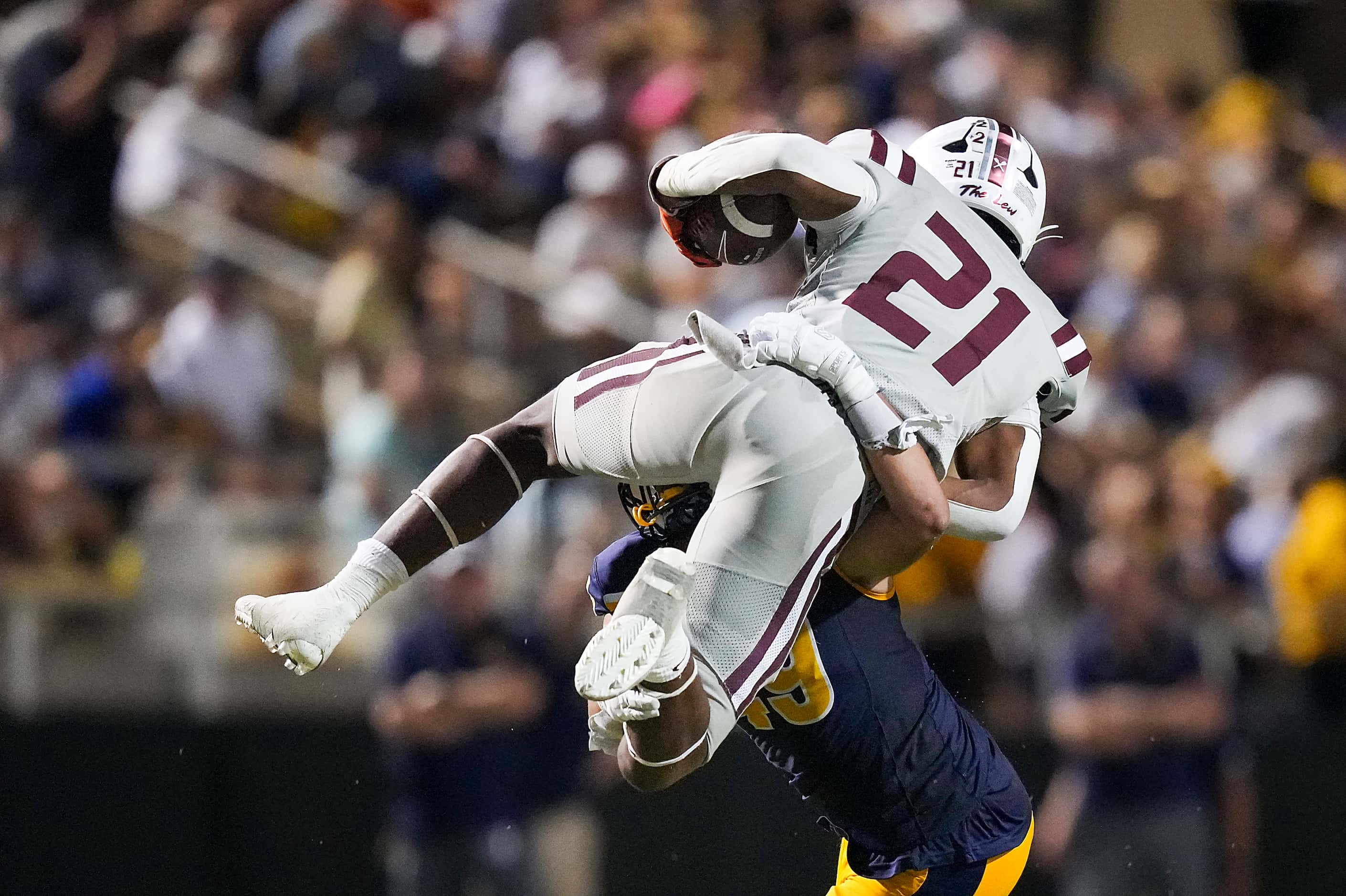 Lewisville running back Viron Ellison (21) is stopped as he tries to leap Highland Park...