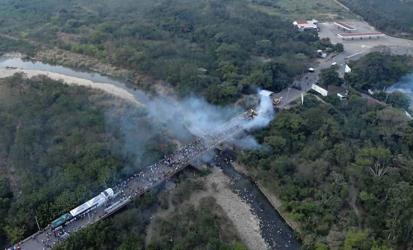 Aerial picture showing demonstrators and smoke billowing from trucks which were carrying...