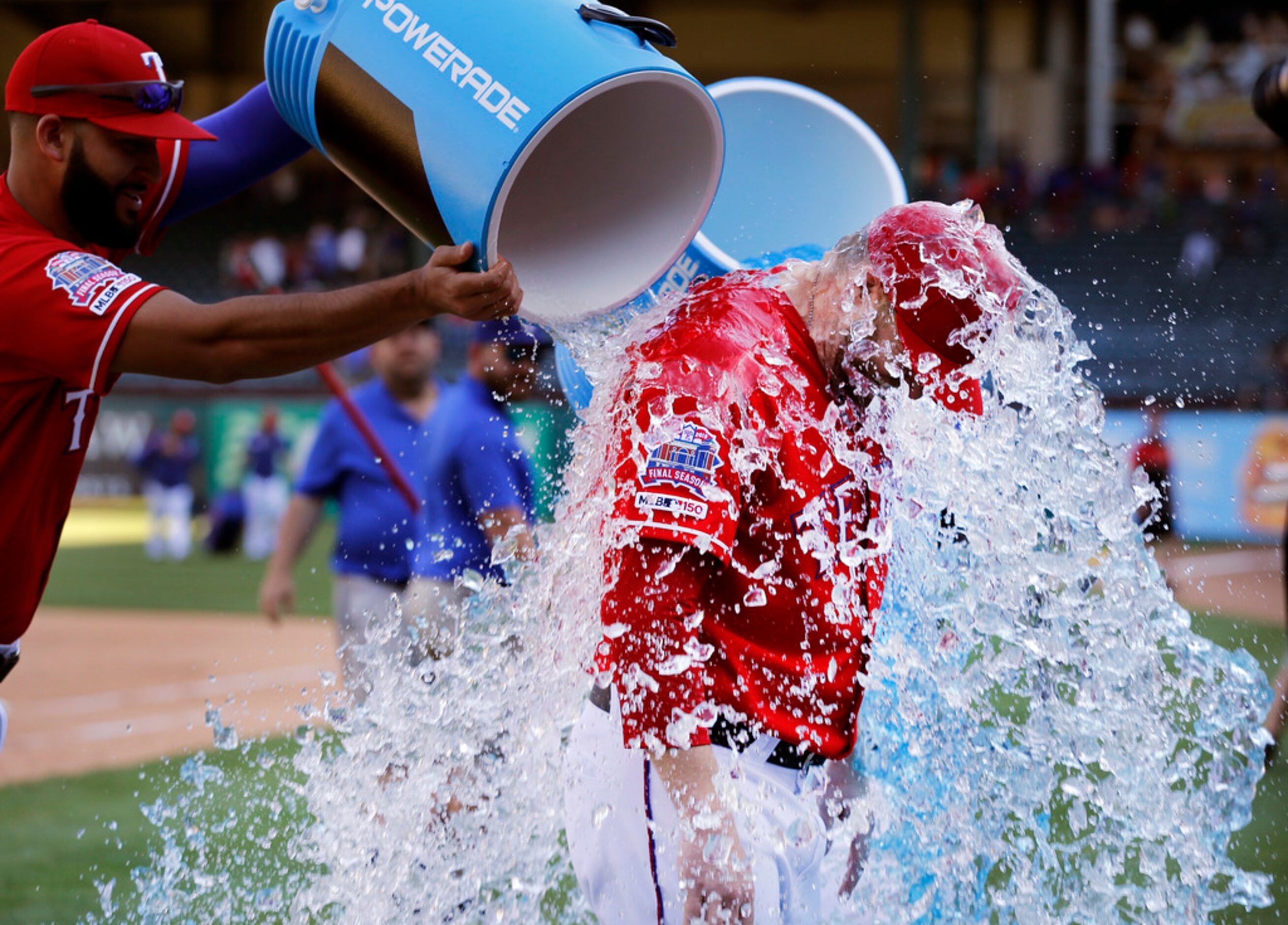 Texas Rangers relief pitcher Shawn Kelley is doused with cold sports drink by teammate Nomar...