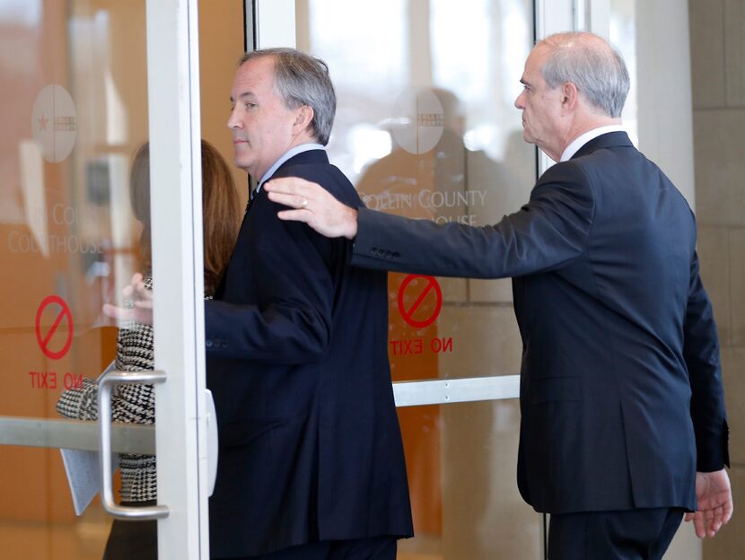 Texas Attorney General Ken Paxton (left) and his attorney Phillip Hilder enter the Collin...