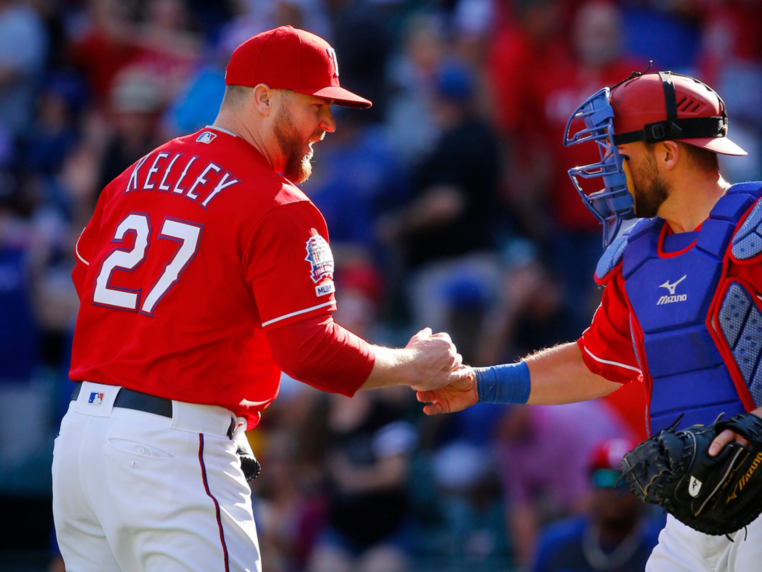 Texas Rangers relief pitcher Shawn Kelley is congratulated by catcher Jeff Mathis after...