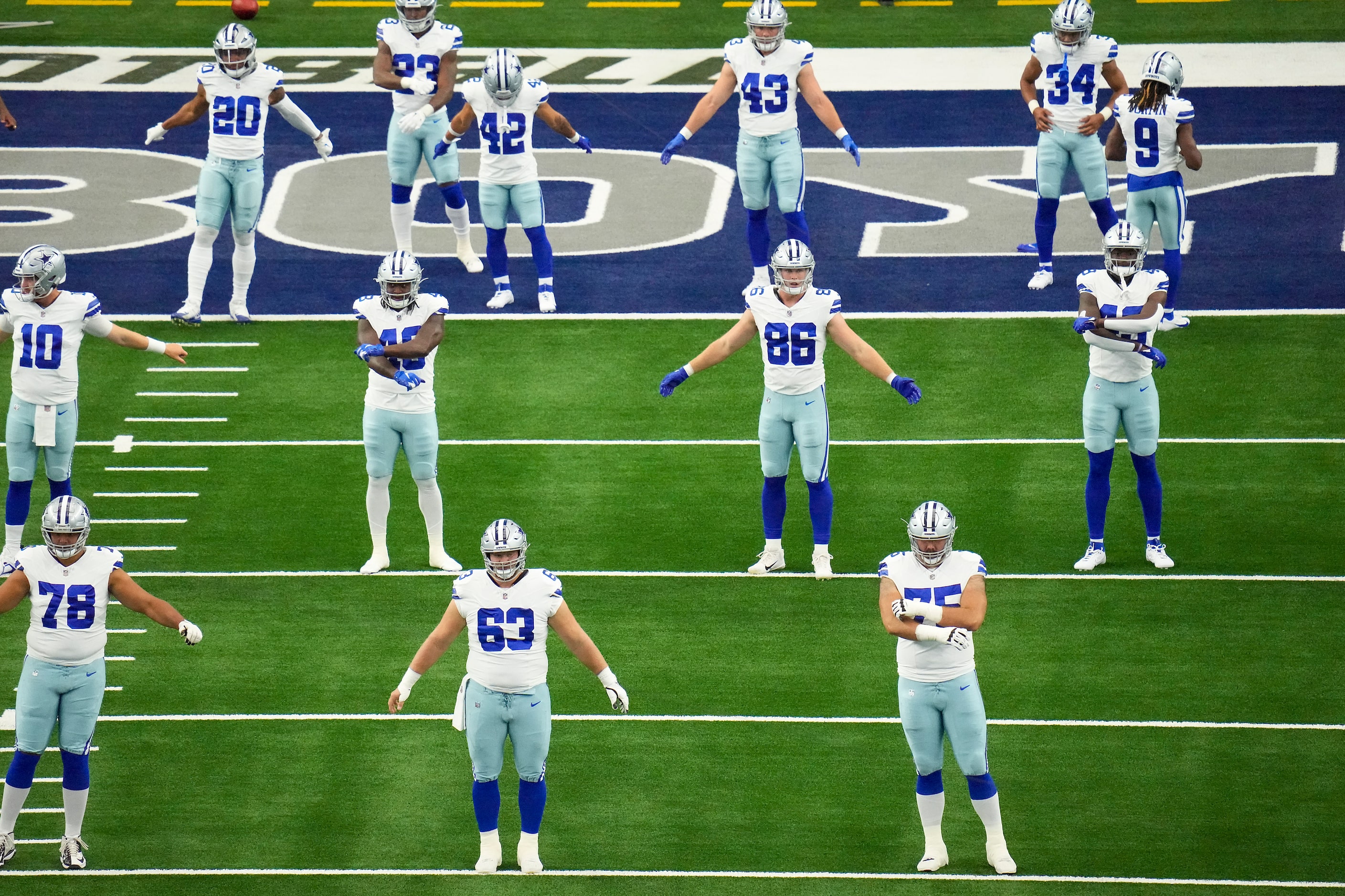 Dallas Cowboys players warm up before an NFL preseason football game against the...