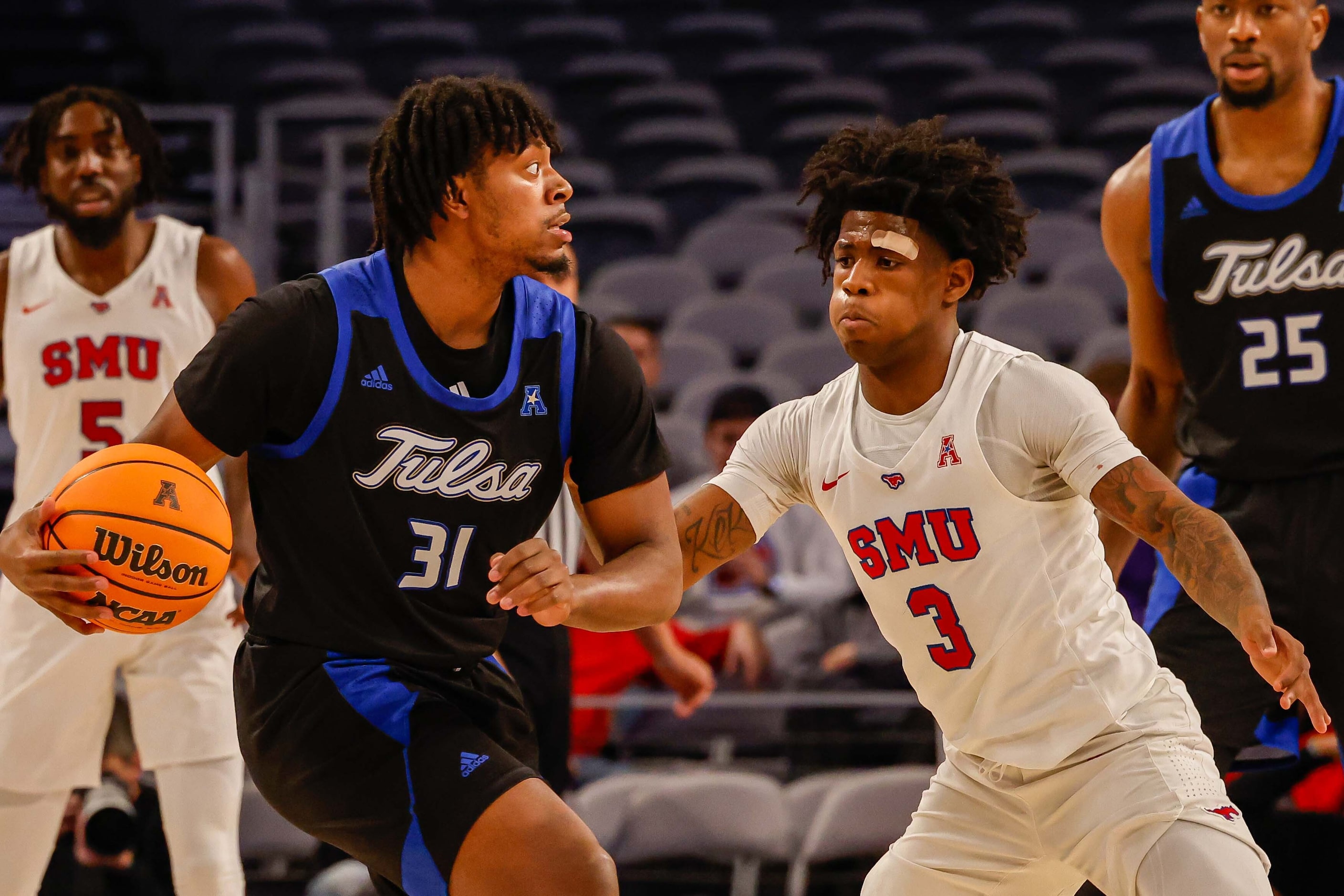 Tulsa Golden Hurricane guard LaDavius Draine (31) tries to make a pass as Southern Methodist...