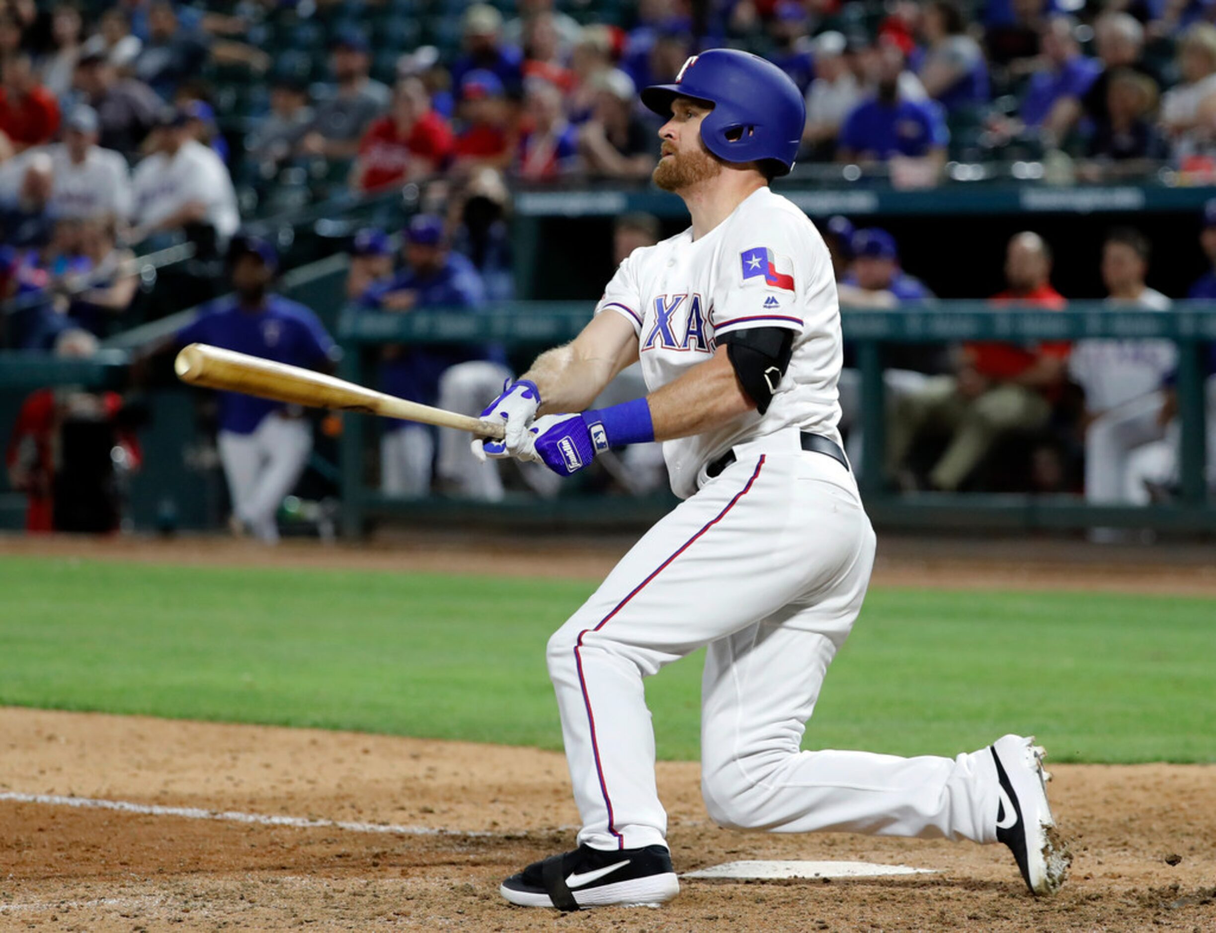 Texas Rangers' Logan Forsythe watches his pinch-hit two-run double in the ninth inning of...