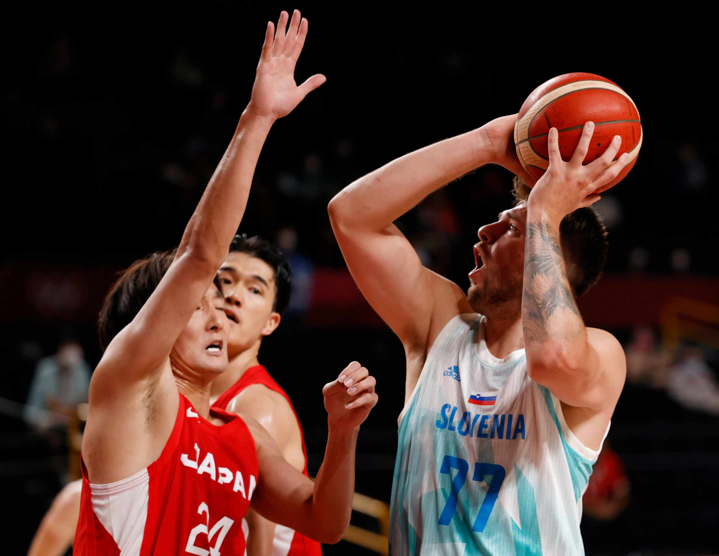 Slovenia’s Luka Doncic (77) attempts a shot after he is fouled by Japan’s Daiki Tanaka (24)...