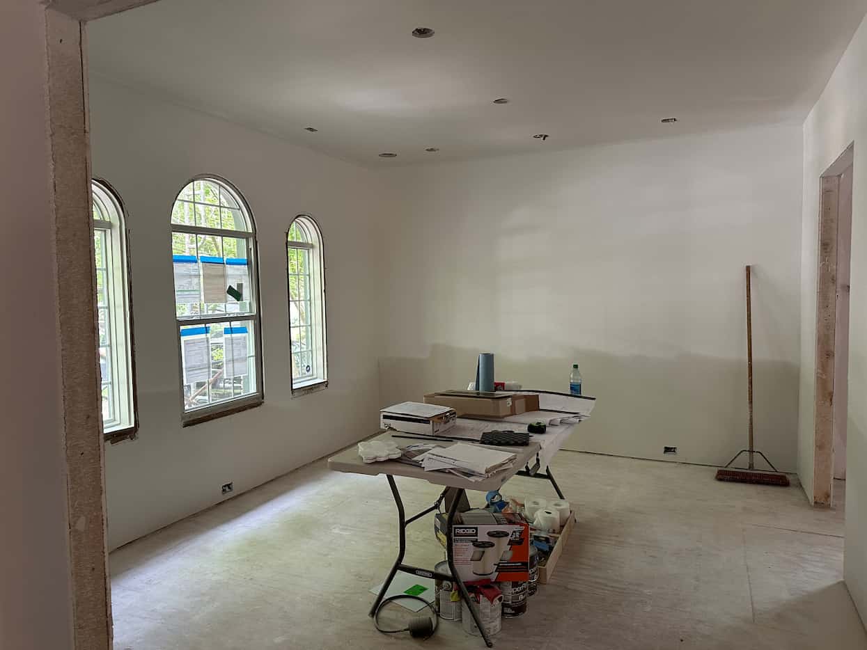 Dining room with arched windows undergoing renovation