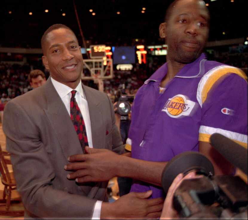 Denver Nuggets scoring standout Alex English, left, is congratulated by Los Angeles Lakers...