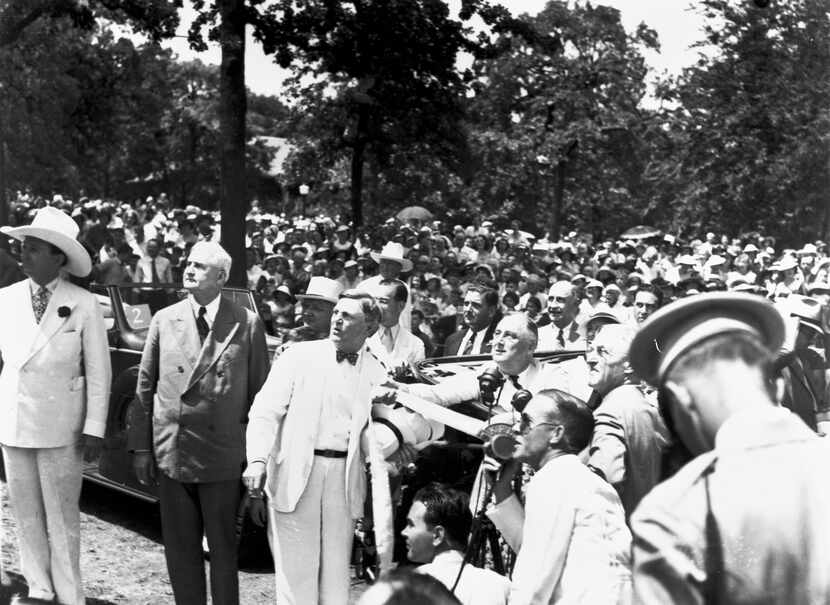 President Franklin D. Roosevelt (seated in car, middle right) pulls a ribbon to unveil the...