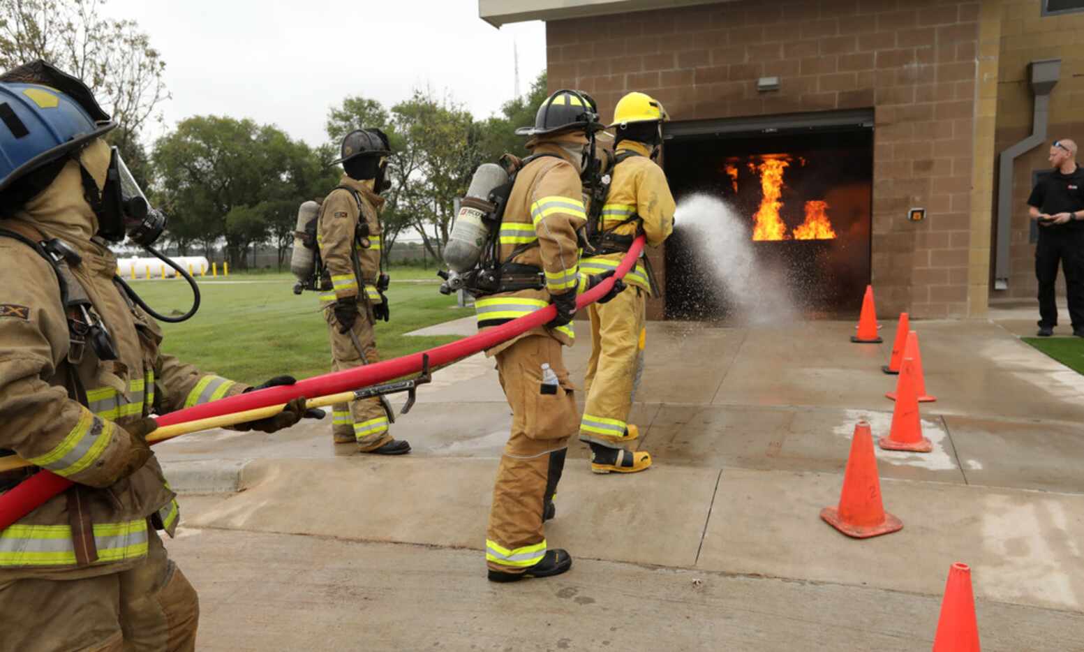 Firefighters practice their techniques at the new Collin College Public Safety Training...