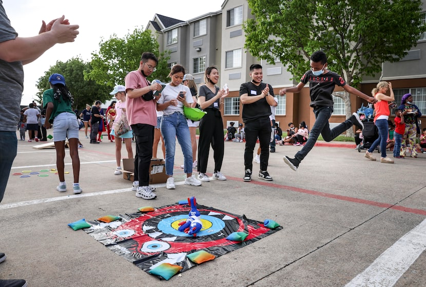 Ash-Meire Lee jumps after making a bullseye while playing a game at Family Gateway North's...