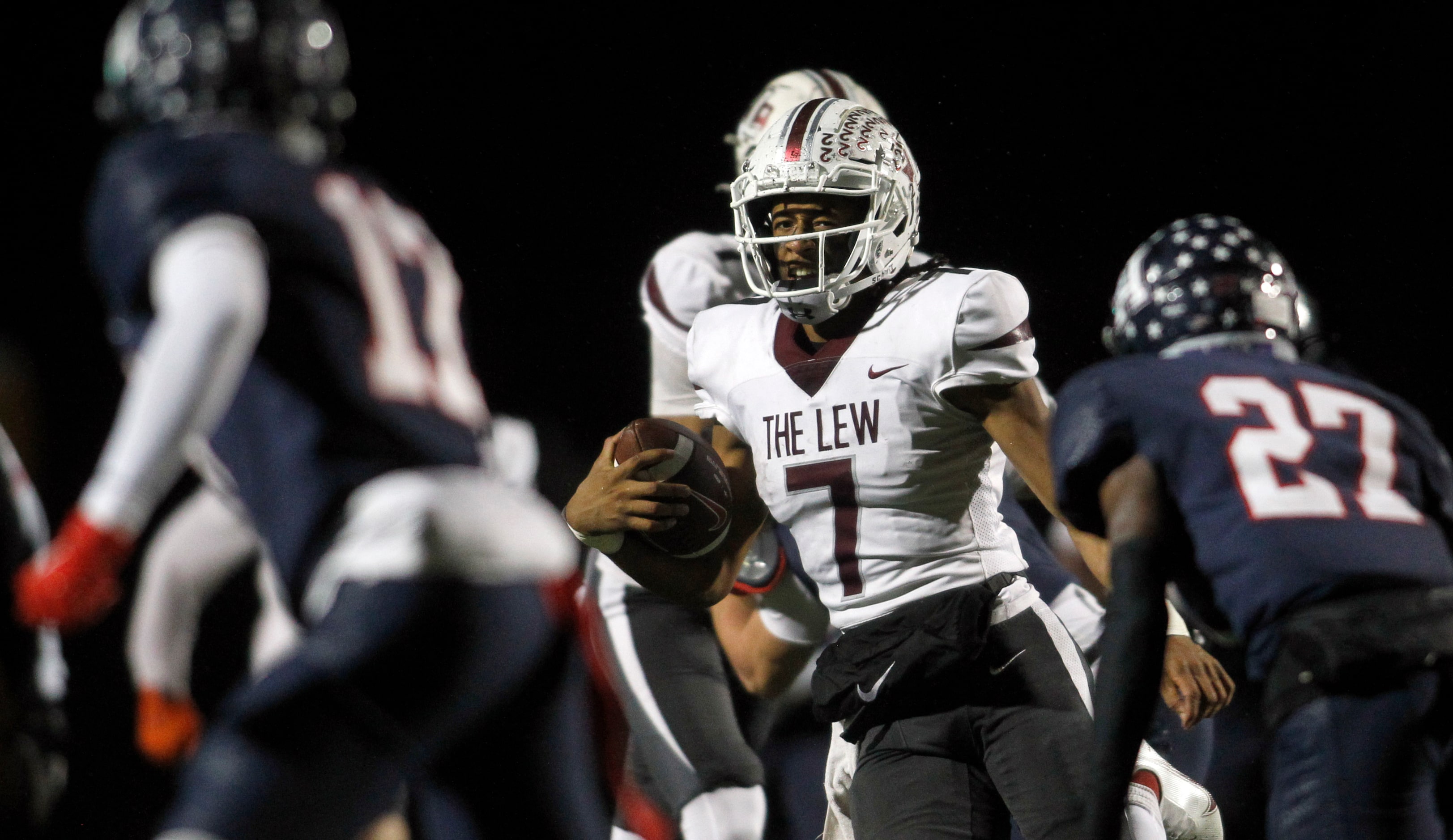 Lewisville quarterback Ethan Terrell (7), center, weaves through the Allen secondary during...