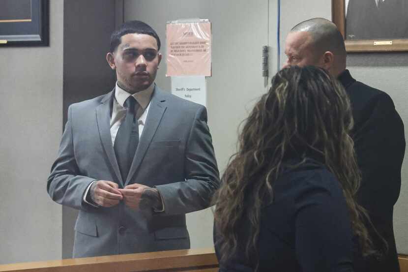 Jordan Rodgers stands talking with family during a break in the trial at Frank Crowley...