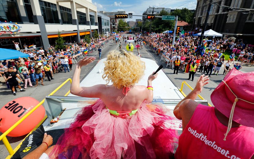 Elliott Puckett waves to the crowd from the "One Community One Love" bus during the Texas...