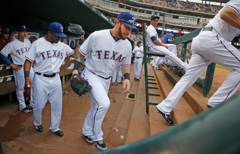 Texas Rangers left fielder Josh Hamilton (32) leaves the dugout as he takes the field with...