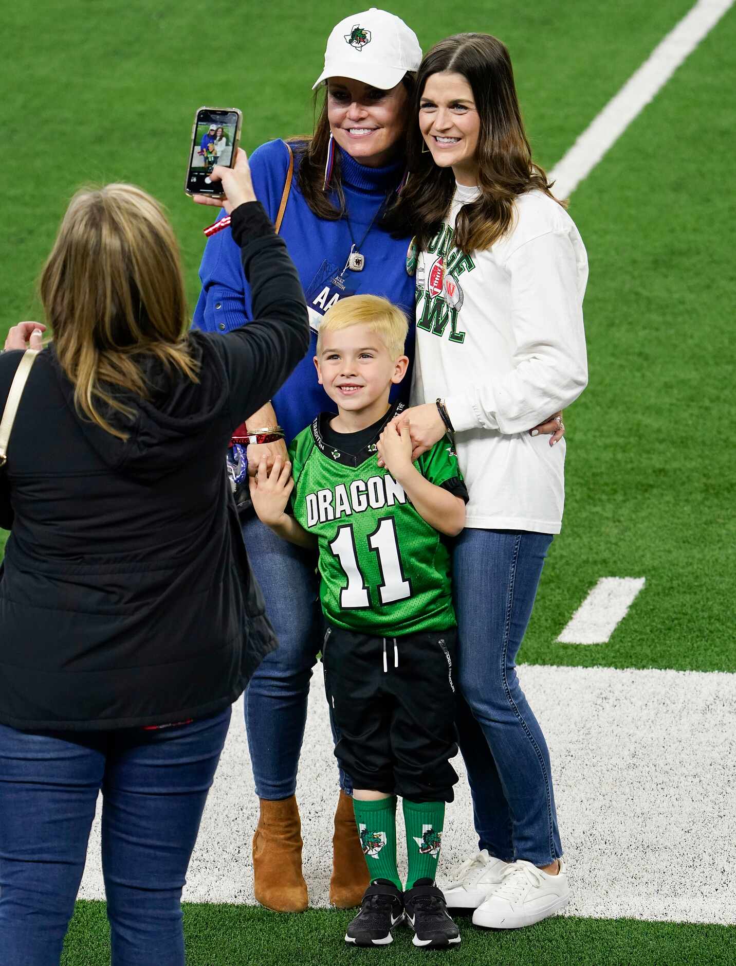 Elizabeth Dodge poses on the field with her grandson Tate, 5, and daughter-in-law Alexis...
