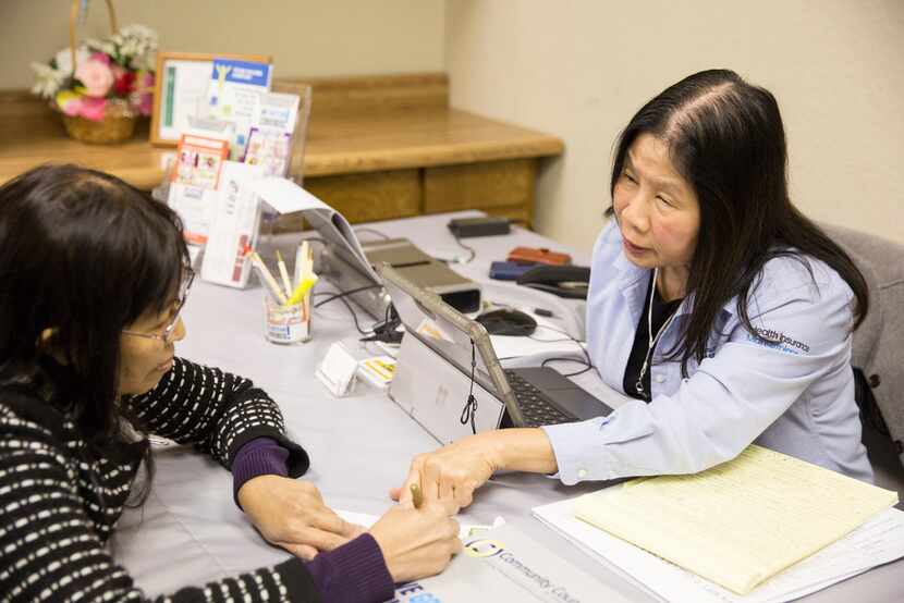 Lisa Pham (right) goes over insurance options with Mua Thi Nguyen at the Vietnamese...