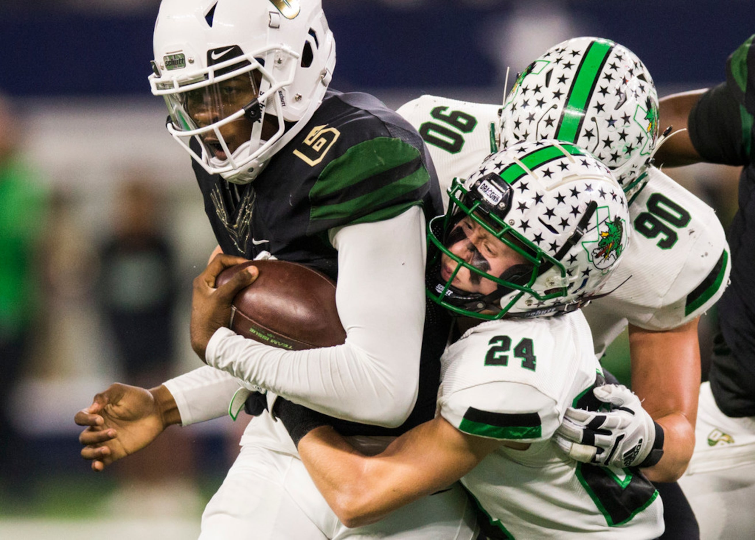 DeSoto quarterback Samari Collier (6) is tackled by Southlake Carroll defensive back Josh...