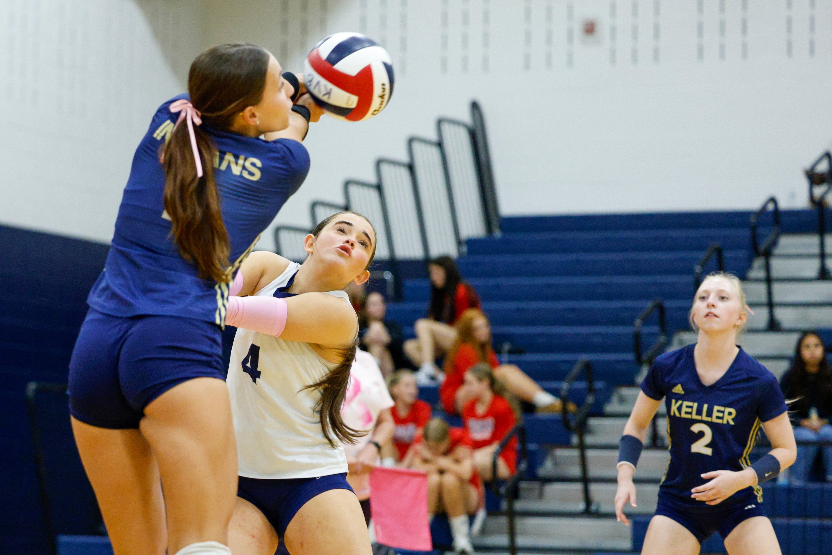 Keller's Sydney Clark (1) digs a serve over Chayse Black (5) during a high school volleyball...