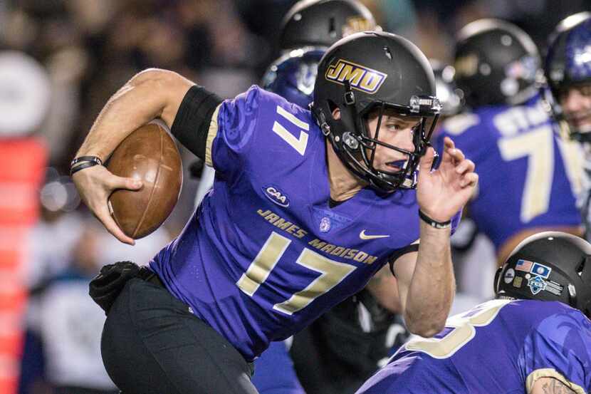 FILE - In this Dec. 8, 2017, file photo, James Madison quarterback Bryan Schor carries the...