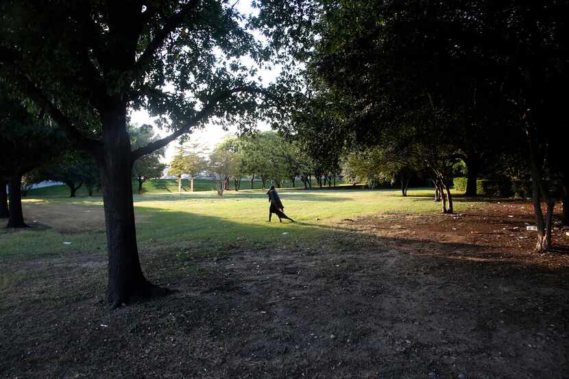 A homeless man drags a blanket in Martyrs Park in Dallas on Oct. 5, 2017. The park is to be...