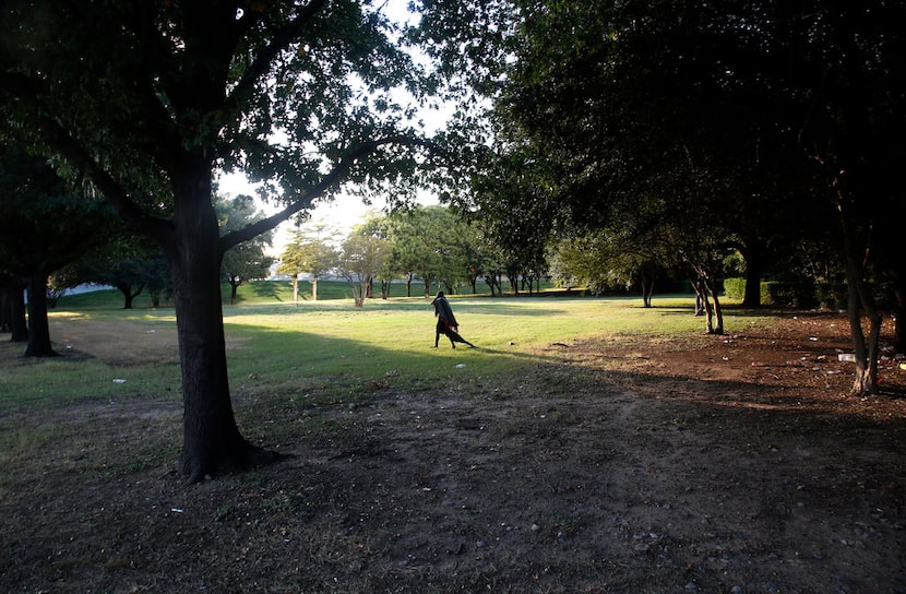 A homeless man drags a blanket in Martyrs Park in Dallas on Thursday, Oct. 5, 2017. The city...