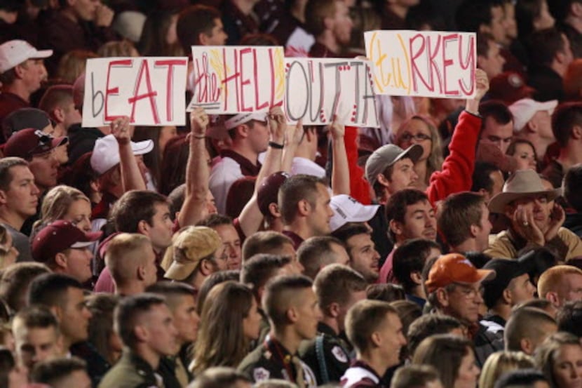 Texas A&M Fans mock Texas with their signs during the first half of their Thanksgiving day...