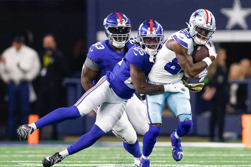New York Giants cornerback Deonte Banks (25) tackles Dallas Cowboys wide receiver CeeDee...