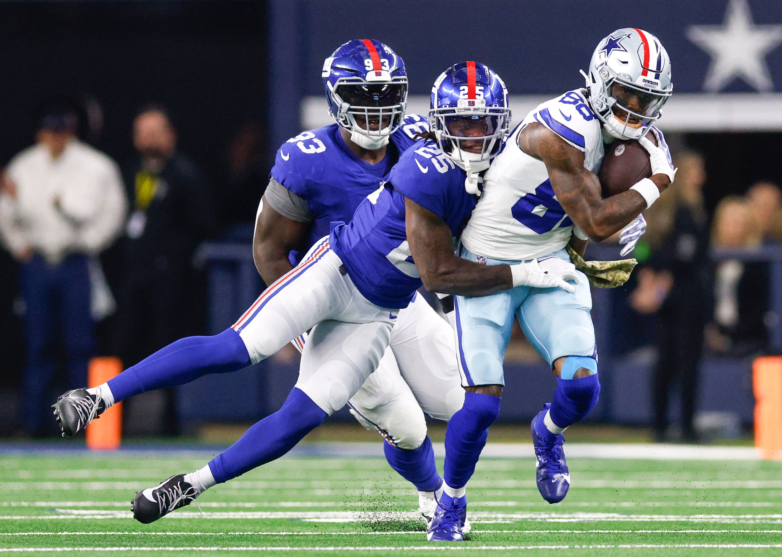 New York Giants cornerback Deonte Banks (25) tackles Dallas Cowboys wide receiver CeeDee...