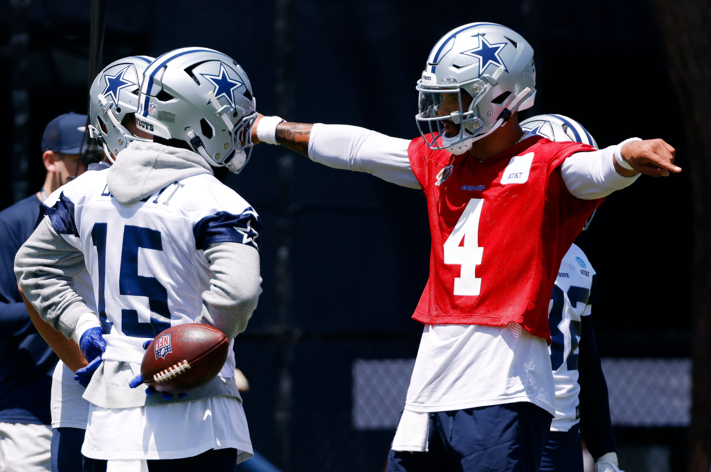 Dallas Cowboys quarterback Dak Prescott (4) works with running back Ezekiel Elliott (15)...