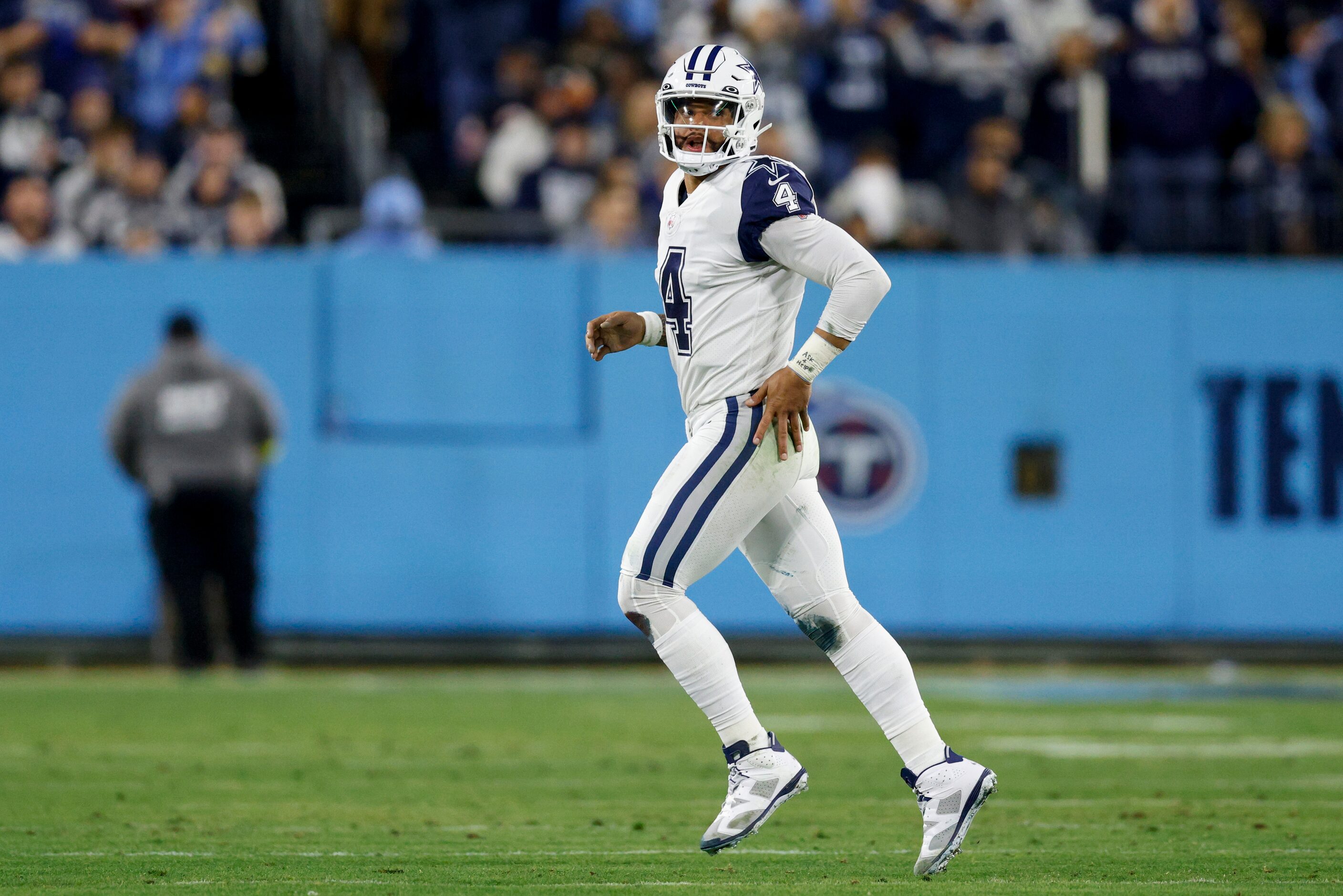 Dallas Cowboys quarterback Dak Prescott (4) jogs off the field after fumbling a snap which...