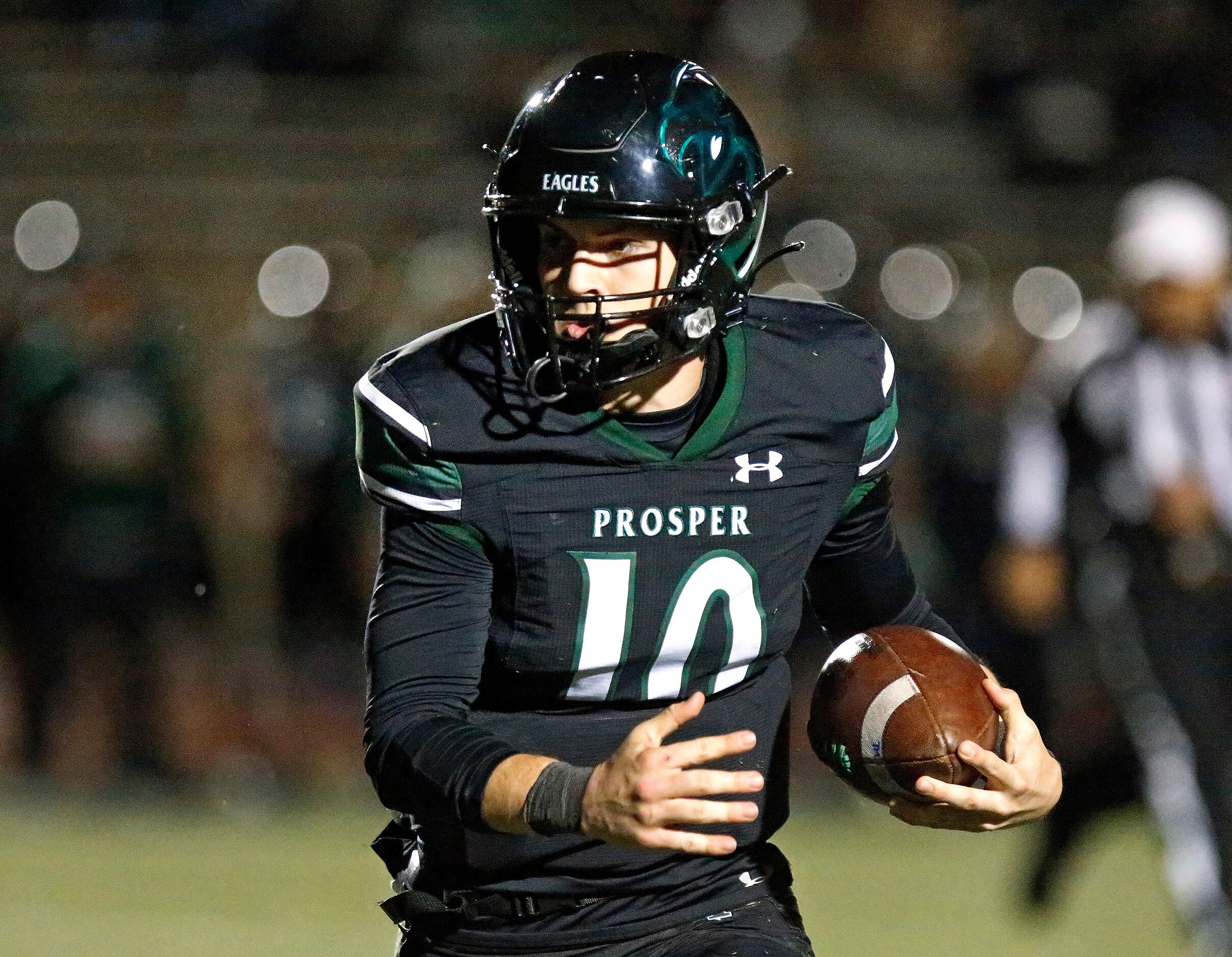 Prosper High School quarterback Harrison Rosar (10) runs the ball during the first half as...