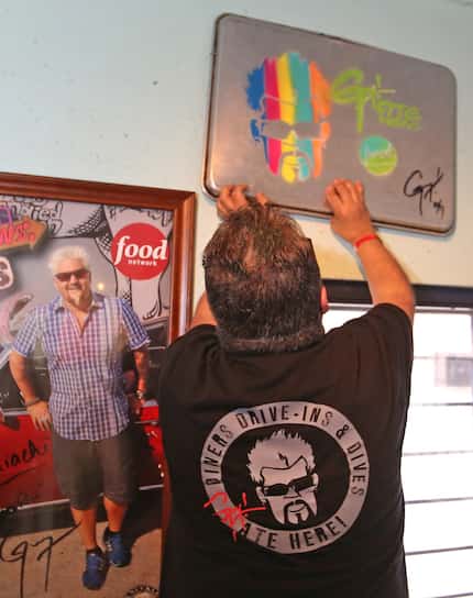 Guy Fieri's likeness is spraypainted on a sheet pan inside Tacos Mariachi, a West Dallas...