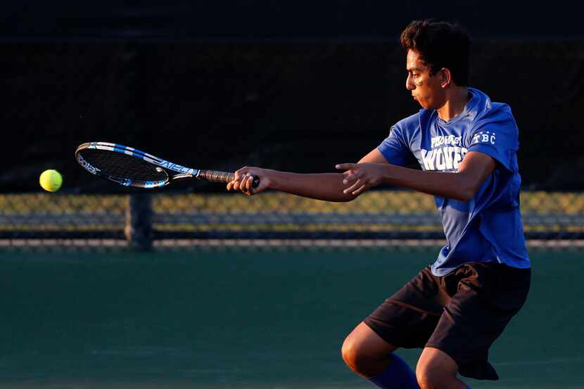 Plano West's Anup Arvind returns the ball in a doubles match with teammate Harrison Sites...
