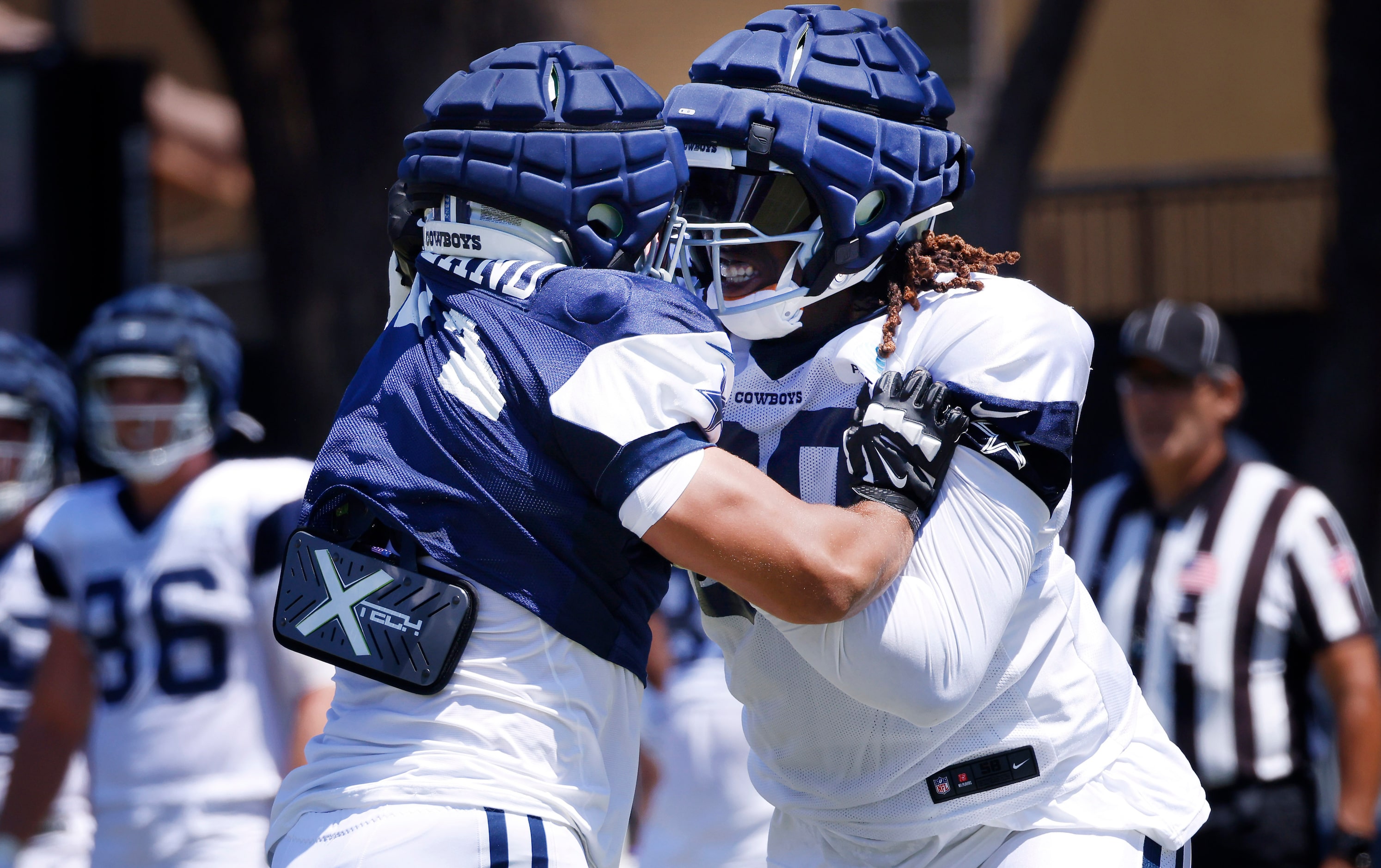 Dallas Cowboys tackle Tyler Guyton (60) blocks defensive end Marshawn Kneeland (94) during a...