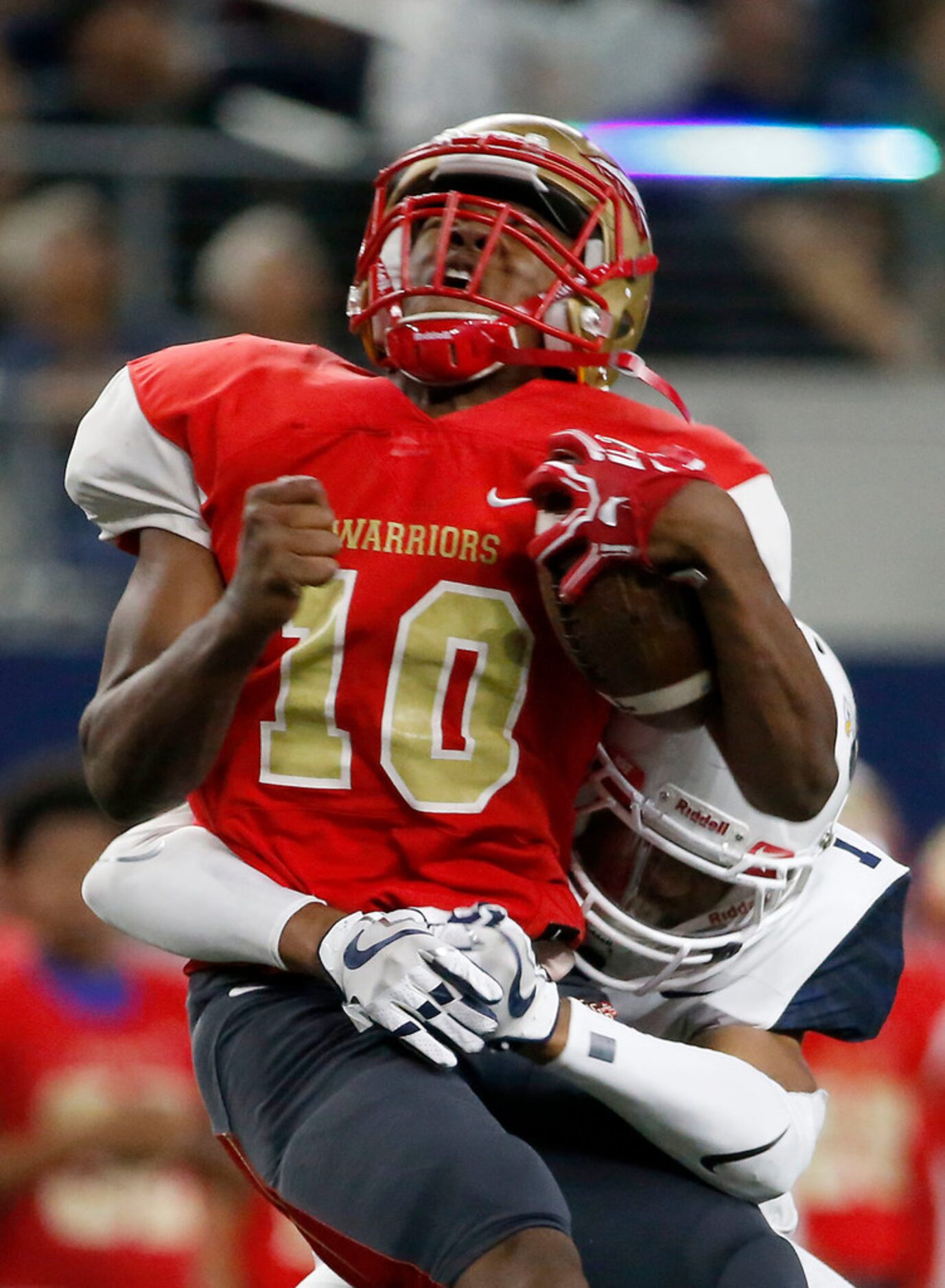 South Grand Prairie quarterback Nakia Brown (10) is tackled by Allen's CJ Johnson (7) during...