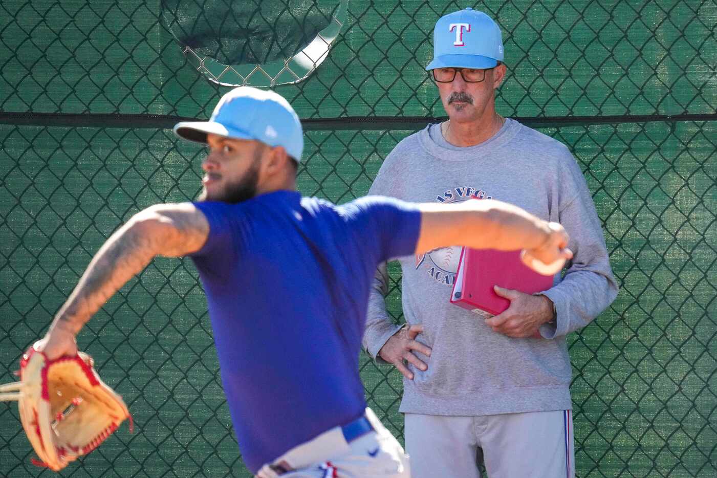 Texas Rangers pitching coach Mike Maddux watches as pitcher Jonathan Hernández throws in the...