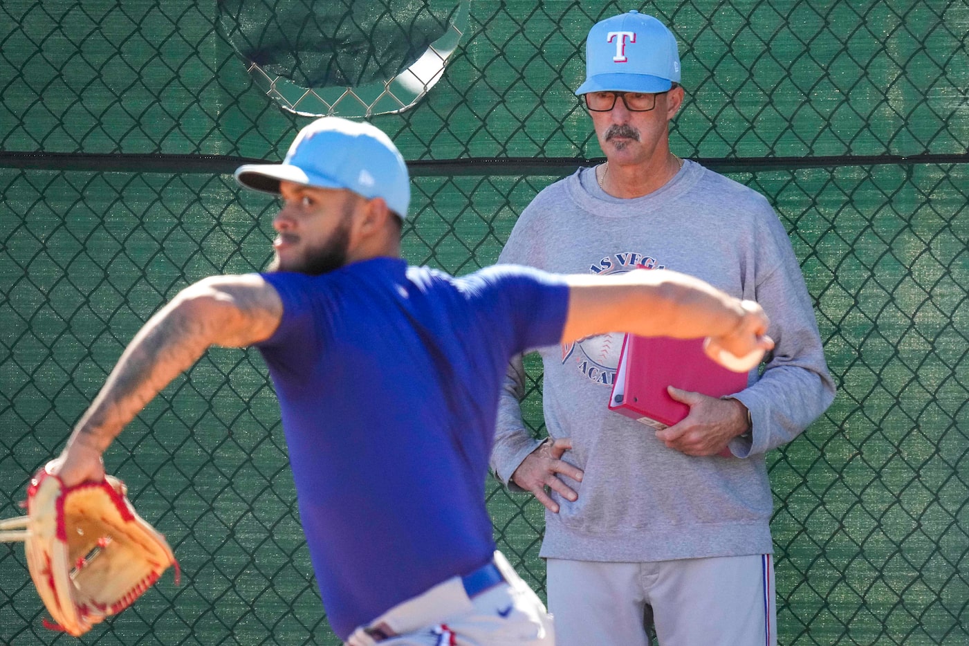 Texas Rangers pitching coach Mike Maddux watches as pitcher Jonathan Hernández throws in the...