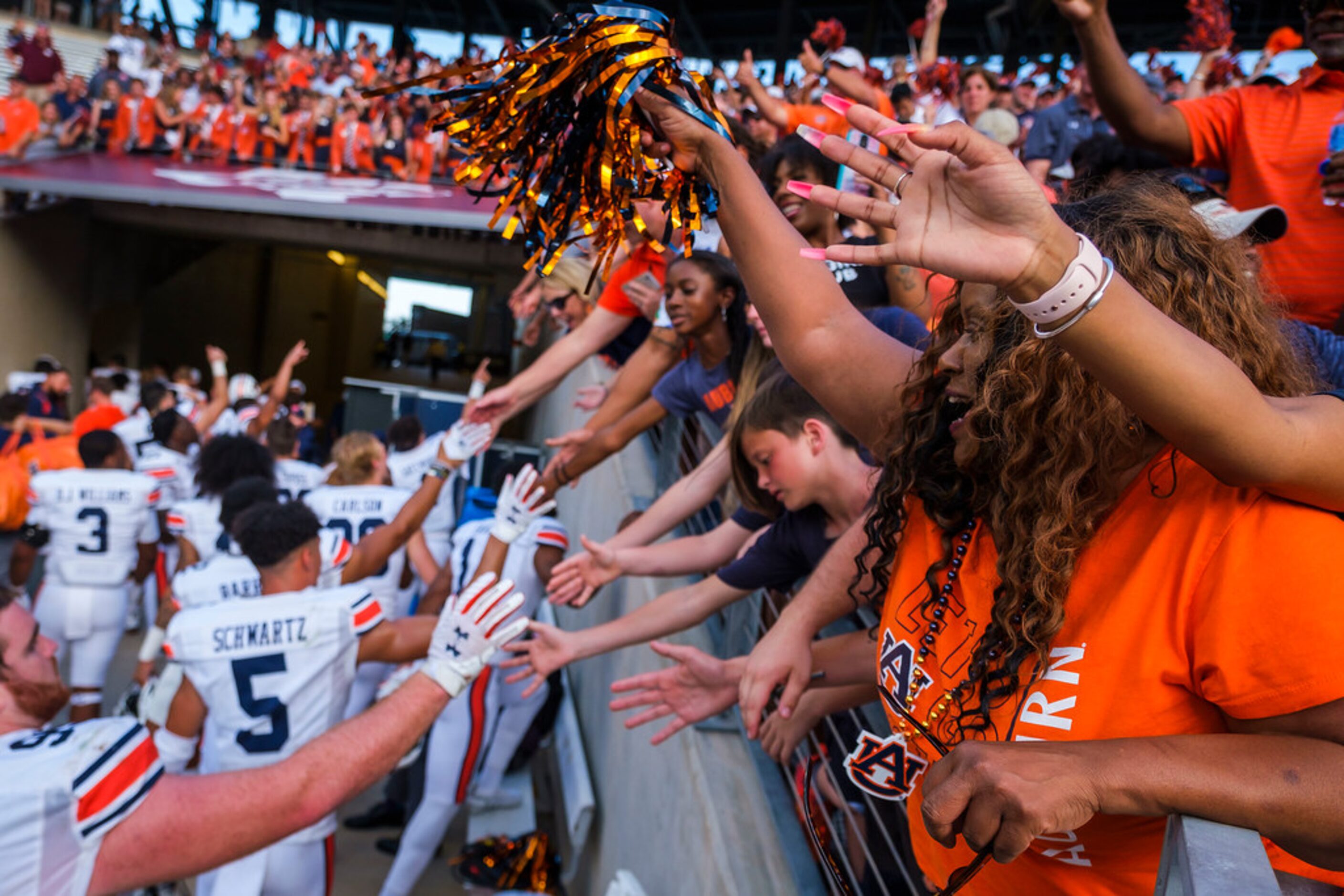 Auburn fans cheer as their team leaves the field after a victory over Texas A&M in an NCAA...