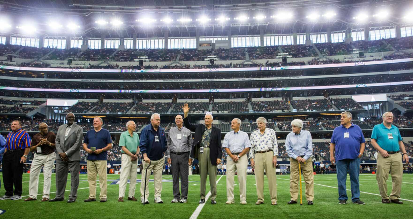 Former Dallas Cowboys player Bob Lilly, (waving, center), and others are honored on the...