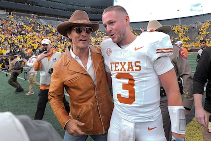 Actor Matthew McConaughey, left, celebrates with Texas quarterback Quinn Ewers (3) after an...