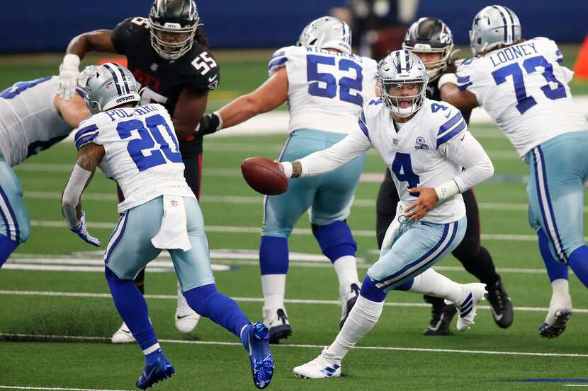 Dallas Cowboys quarterback Dak Prescott (4) fakes he handoff to Dallas Cowboys running back...