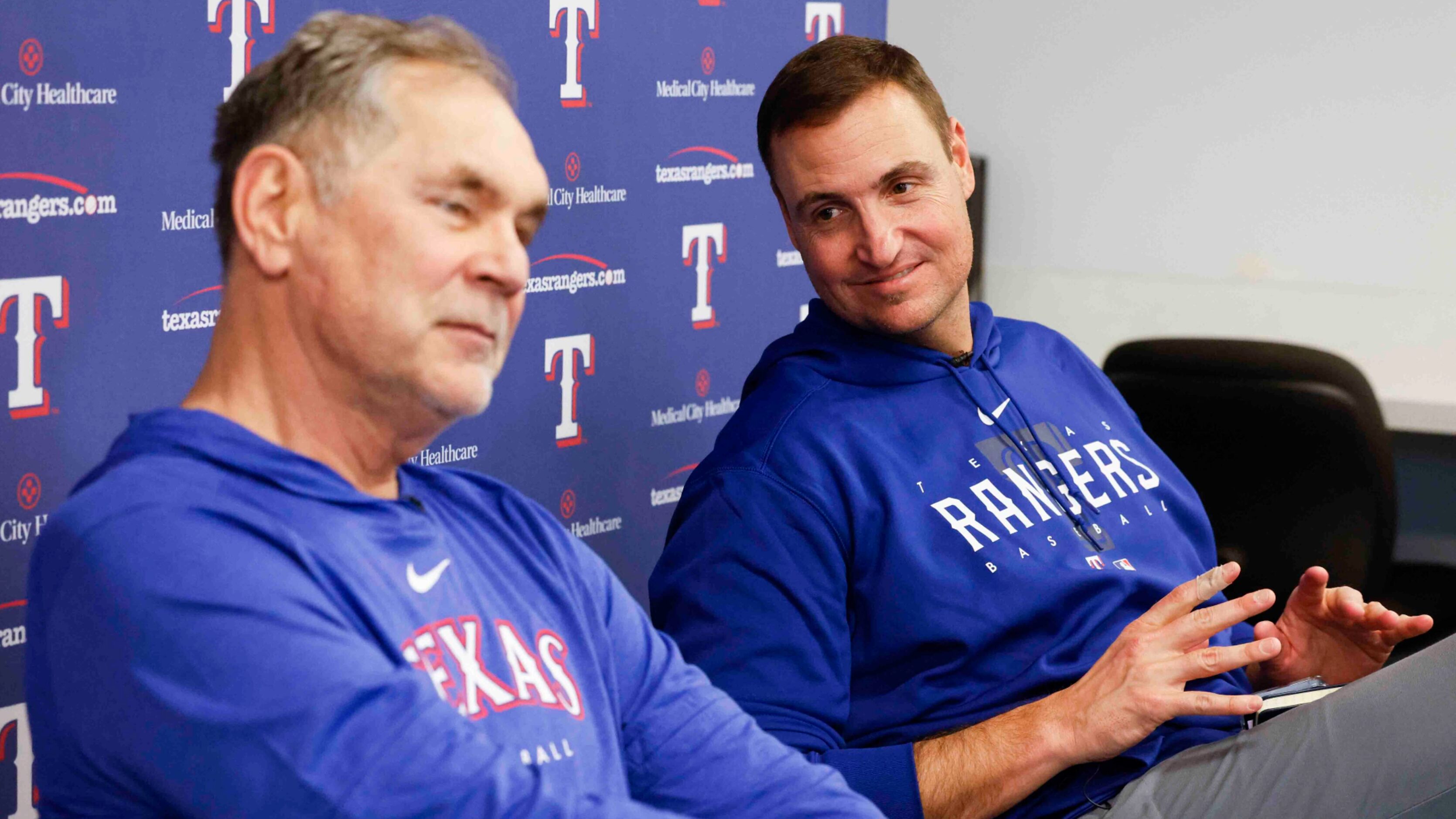 Texas Rangers manager Bruce Bochy, left, talks to the members of the media as executive vice...