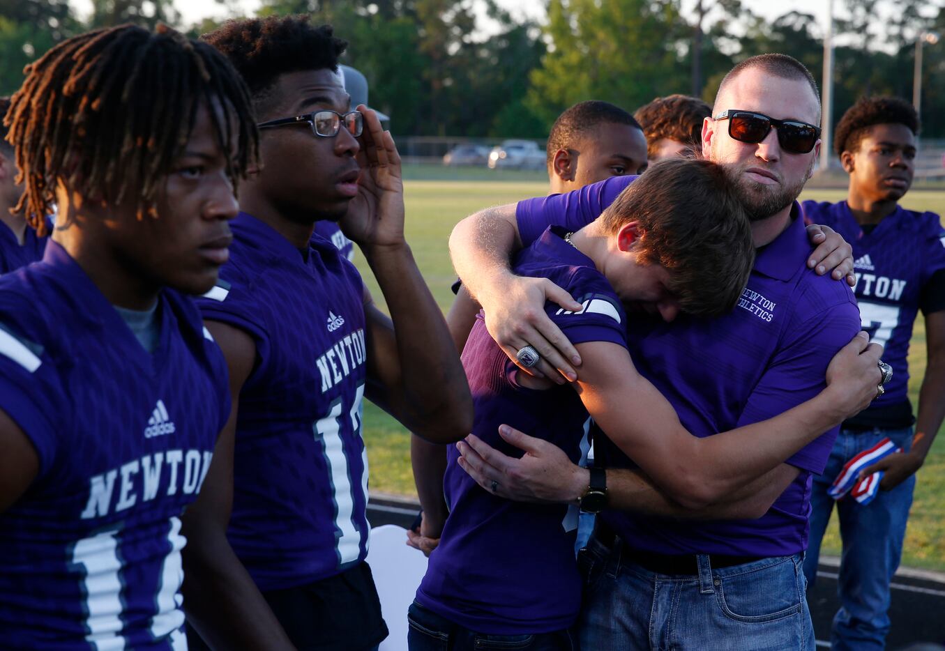 Current head football coach and son Drew Johnston hugs Newton's Nate Williams (6) during the...