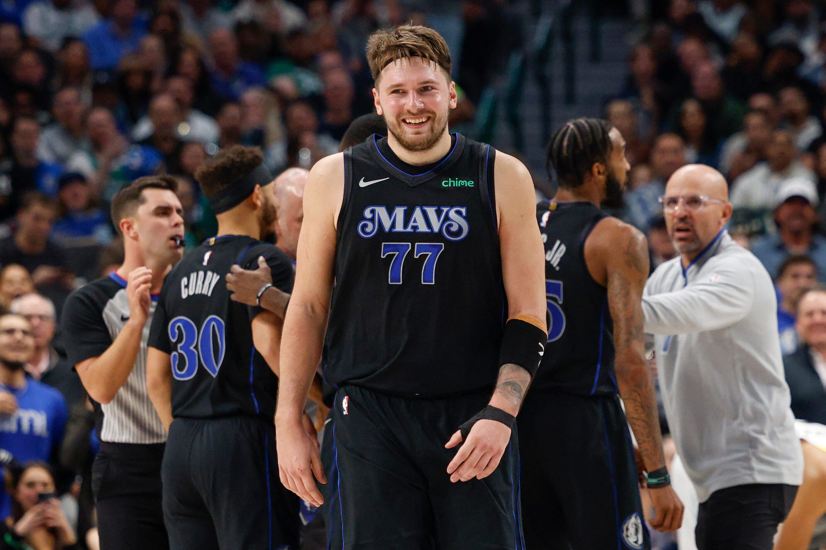 Dallas Mavericks guard Luka Doncic (77) smiles after an exchange of words with Utah Jazz...