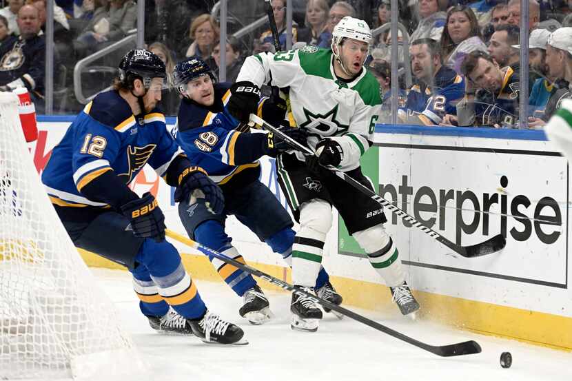 Dallas Stars right wing Evgenii Dadonov (63) fights for the puck against St. Louis Blues'...