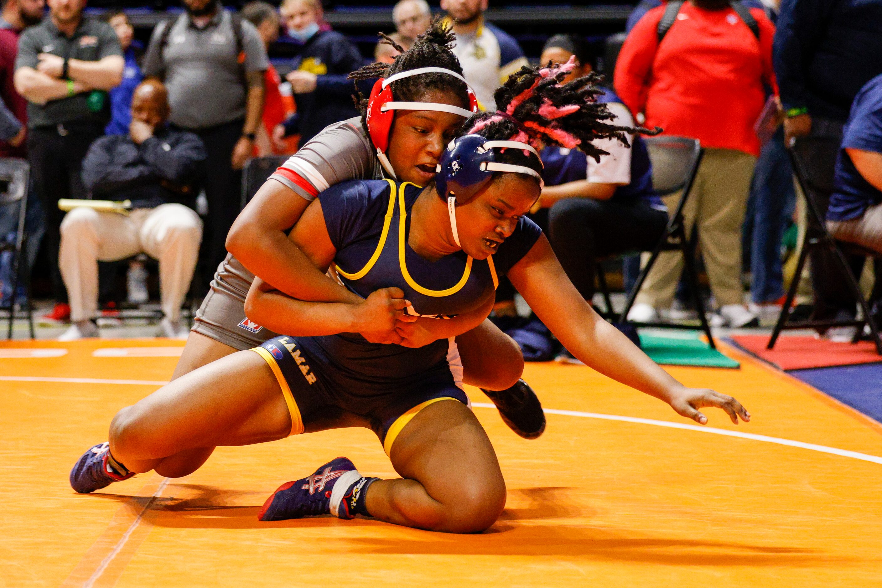 Samria Barnett of Converse Judson (left) wrestles Nya Woods of Arlington Lamar during a...