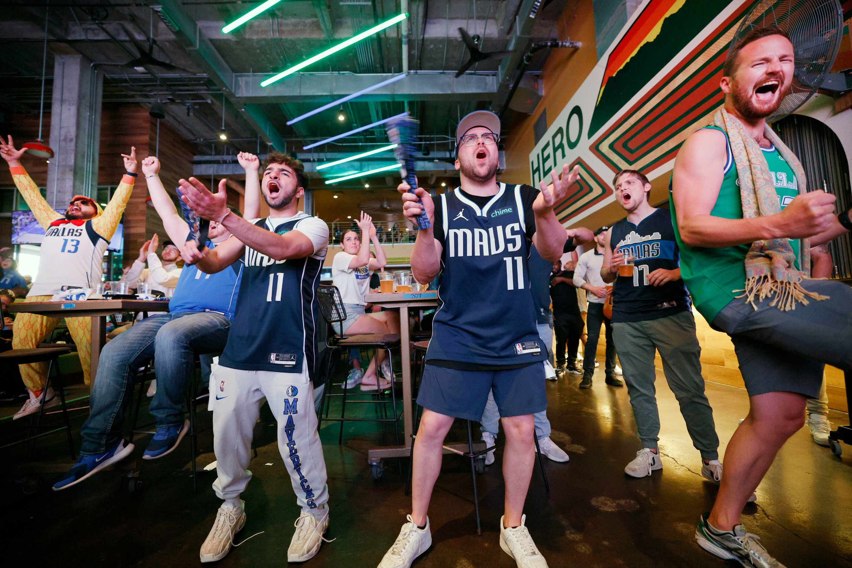 Dallas Mavericks fans including Matthew Singer of Dallas, second from right, cheer during a...